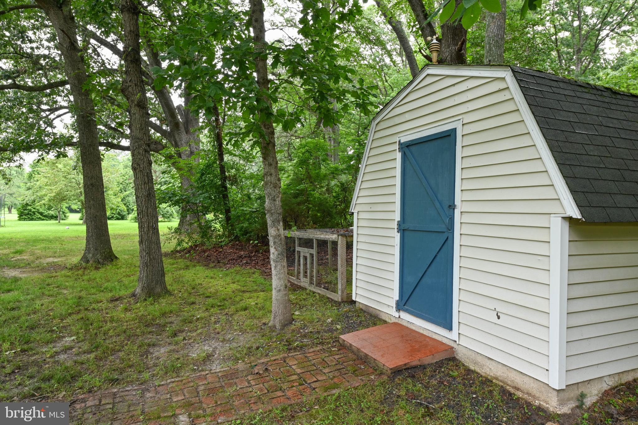 26698 Arcadia Shores Road Easton, MD 21601 - Photo 65 of 71 Charming shed nestled in a lush green setting.