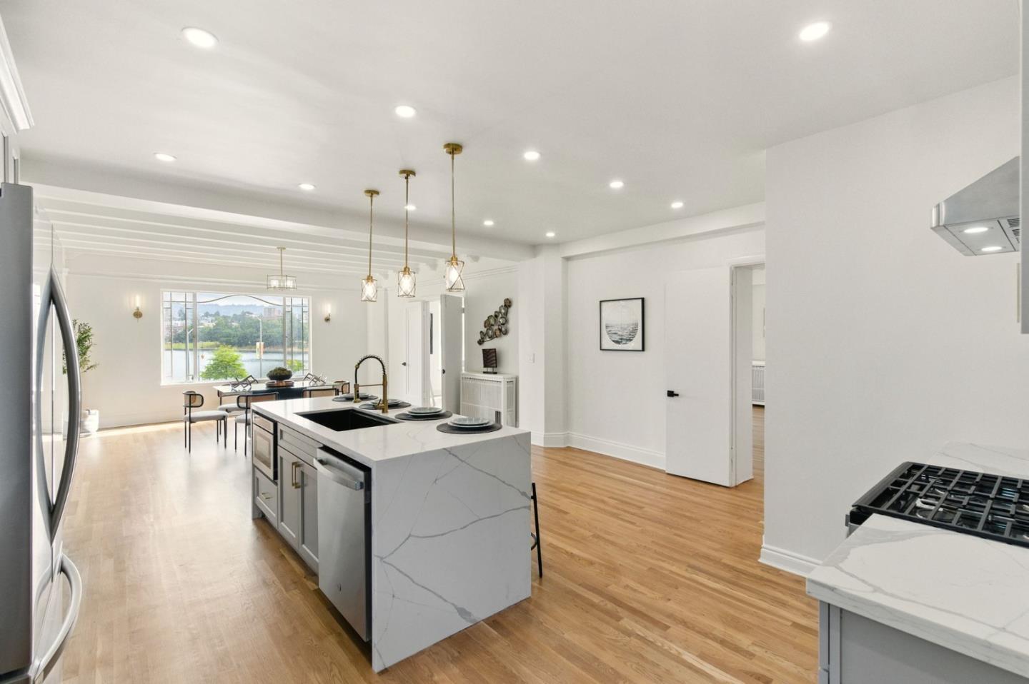 244 Lakeside Drive, Unit 202 Oakland, CA 94612 - Photo 11 of 32 a kitchen with stainless steel appliances granite countertop a stove and a refrigerator