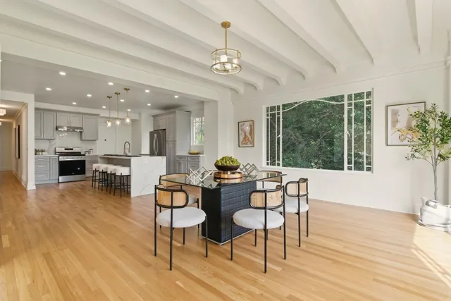 a dining room with furniture and wooden floor