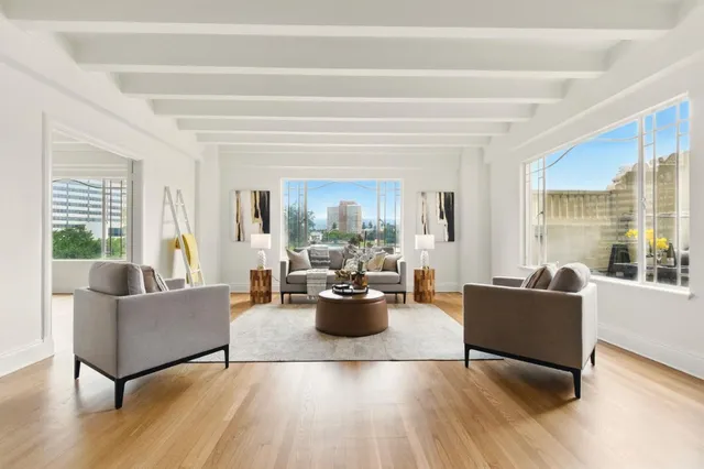 a bedroom with a large bed and a large window