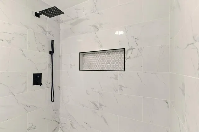 a bathroom with a bathtub and a shower