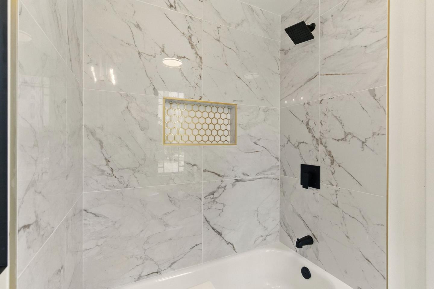 244 Lakeside Drive, Unit 202 Oakland, CA 94612 - Photo 27 of 32 a bathroom with a bathtub and a shower