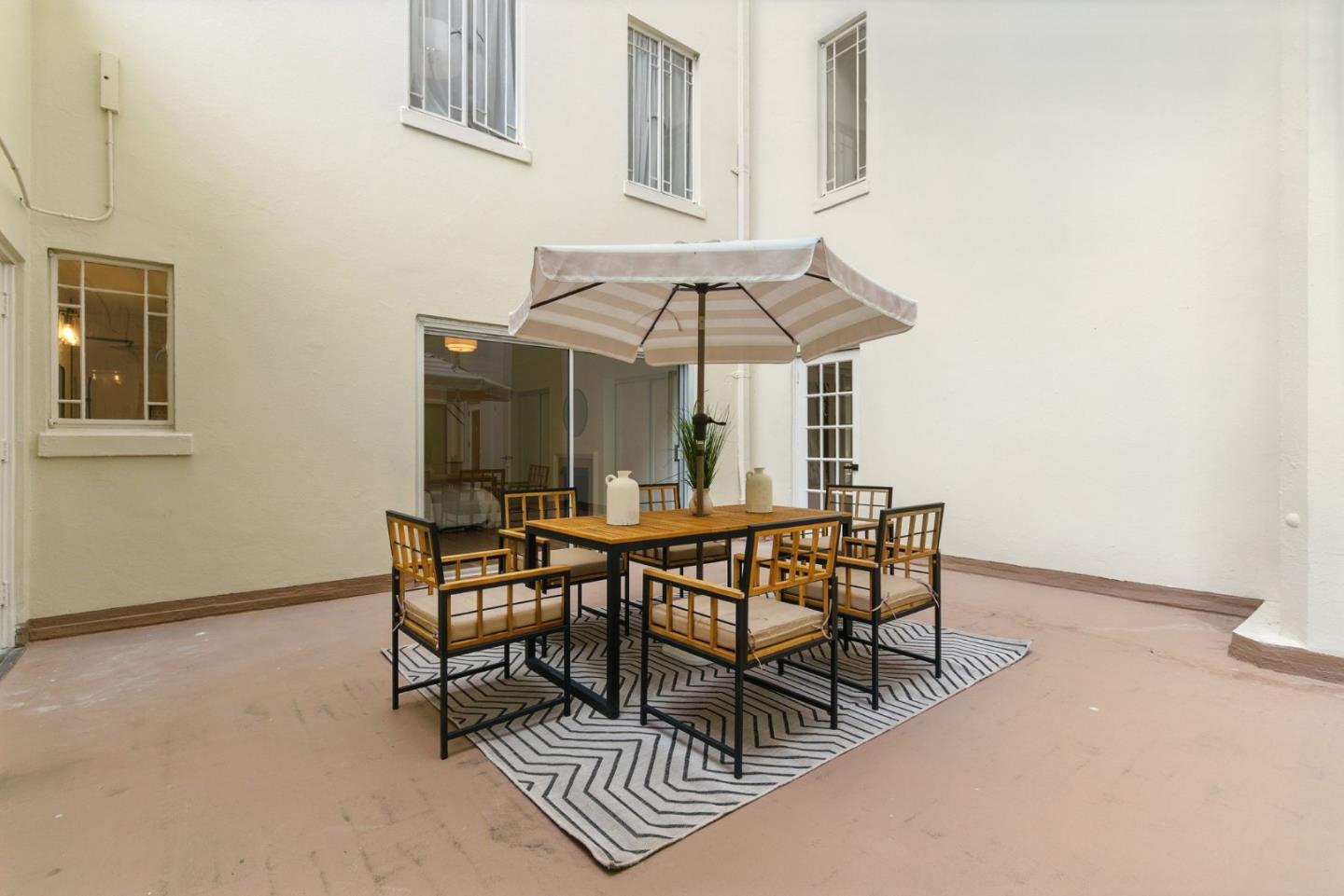 244 Lakeside Drive, Unit 202 Oakland, CA 94612 - Photo 28 of 32 a view of a dining room with furniture and chandelier