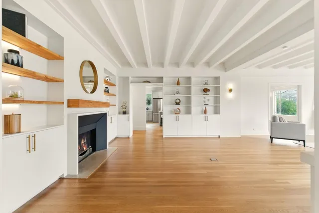 a view of an empty room with window and fireplace