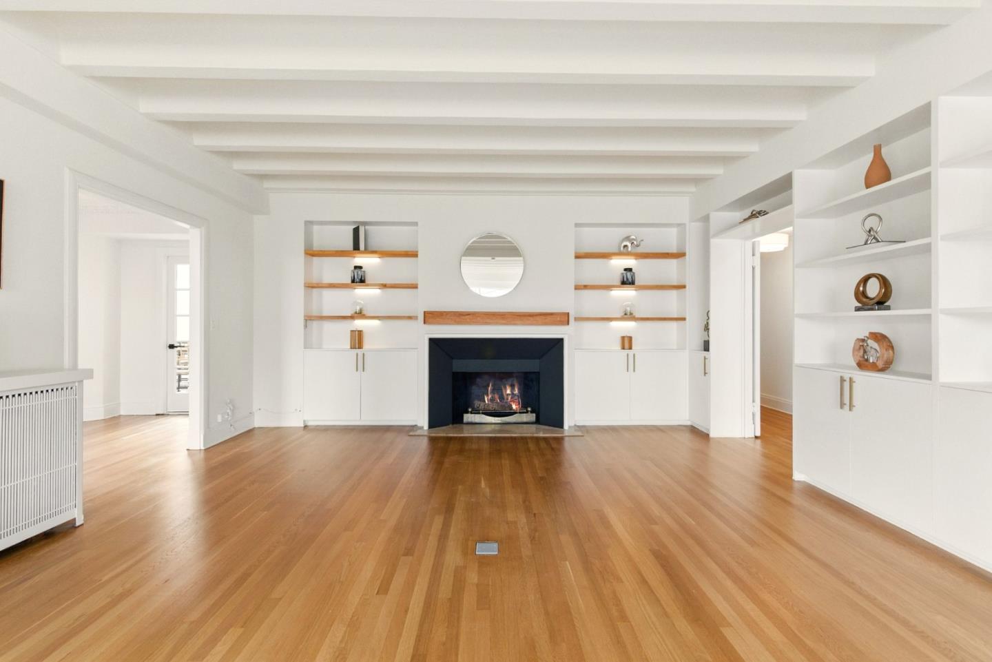 244 Lakeside Drive, Unit 202 Oakland, CA 94612 - Photo 4 of 32 a view of a livingroom with wooden floor and a fireplace