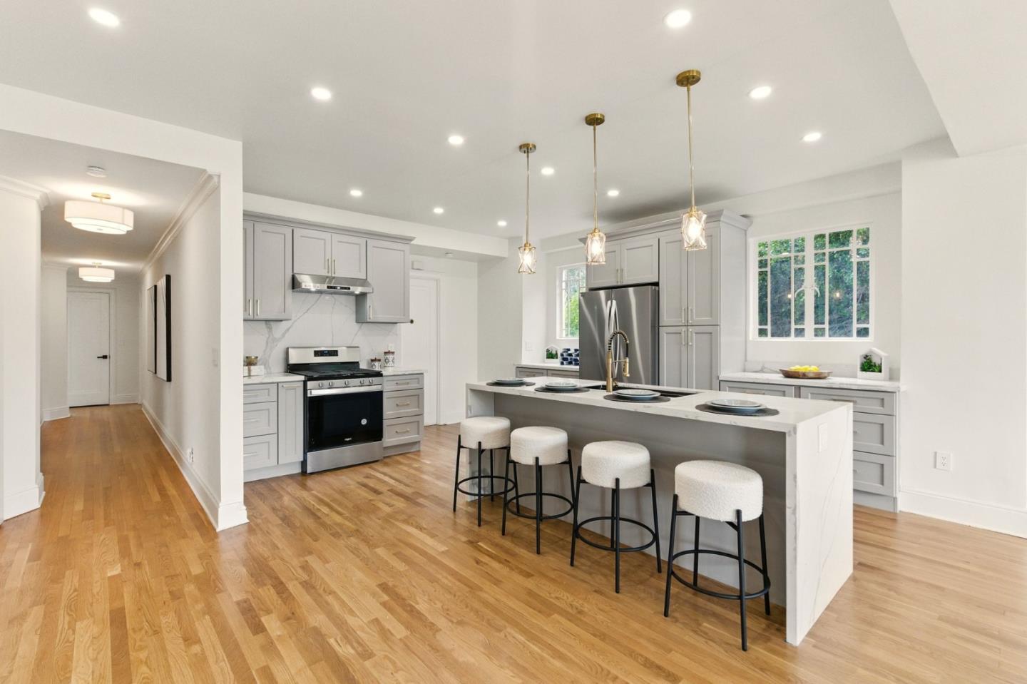 244 Lakeside Drive, Unit 202 Oakland, CA 94612 - Photo 9 of 32 a kitchen with stainless steel appliances granite countertop a stove top oven a sink dishwasher a refrigerator and a dining table with wooden floor