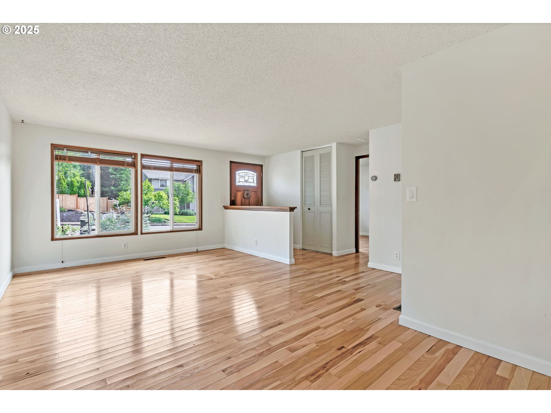 590 Granite Place Springfield, OR 97477 - Photo 2 of 21 a view of an empty room with wooden floor and a window