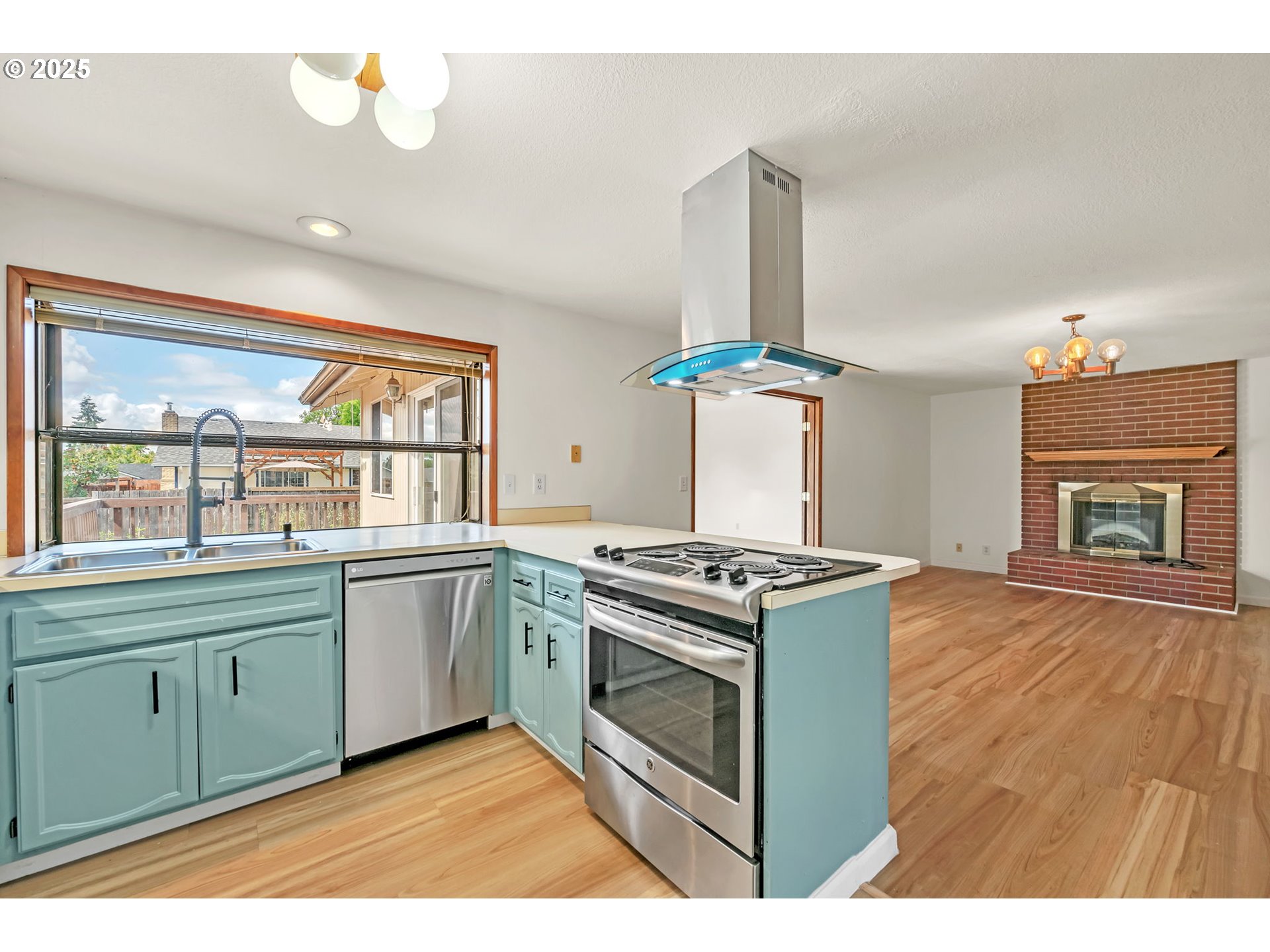 590 Granite Place Springfield, OR 97477 - Photo 4 of 21 a kitchen with stainless steel appliances granite countertop a stove and a sink
