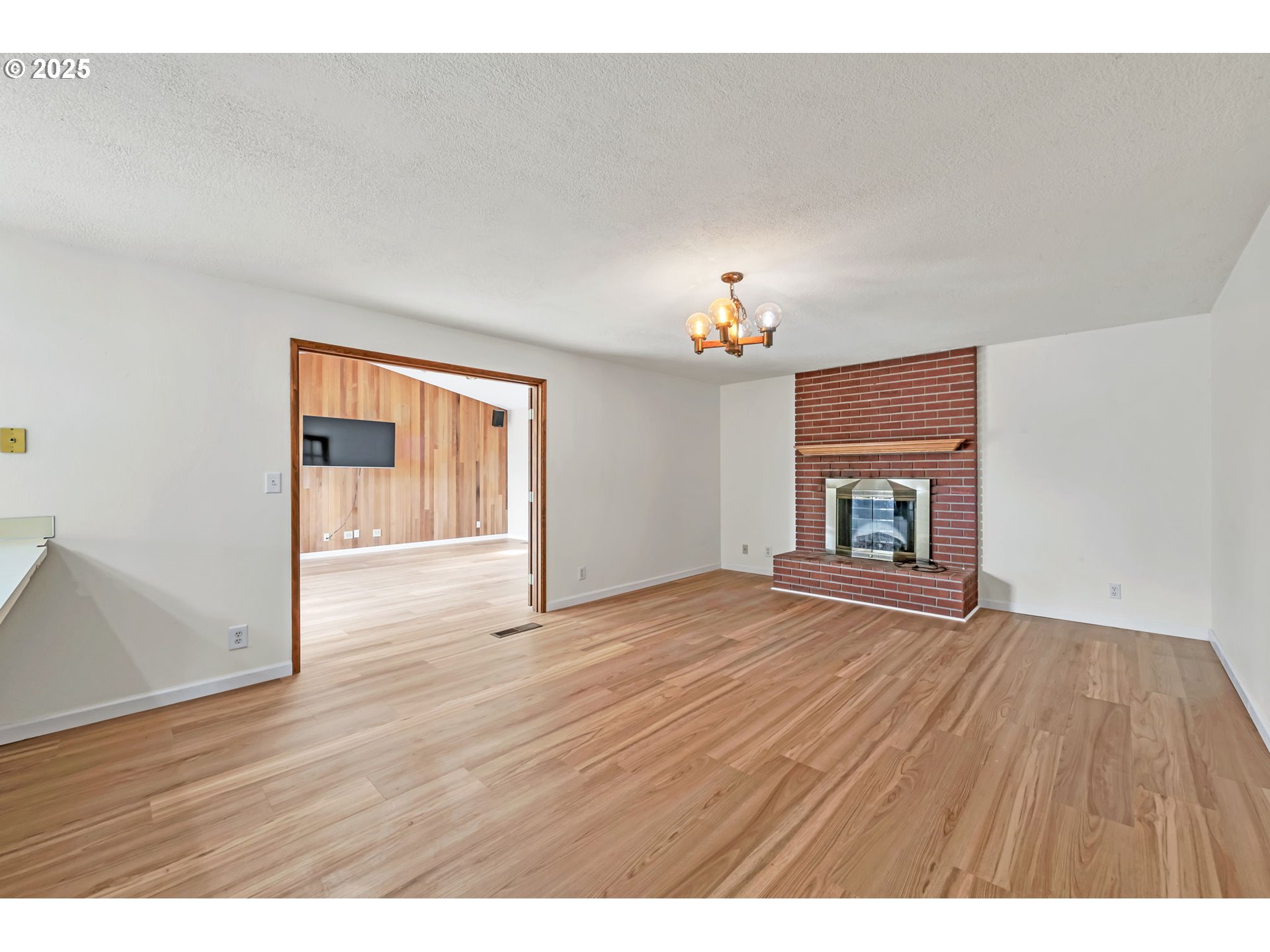 590 Granite Place Springfield, OR 97477 - Photo 5 of 21 a view of empty room with wooden floor and fireplace