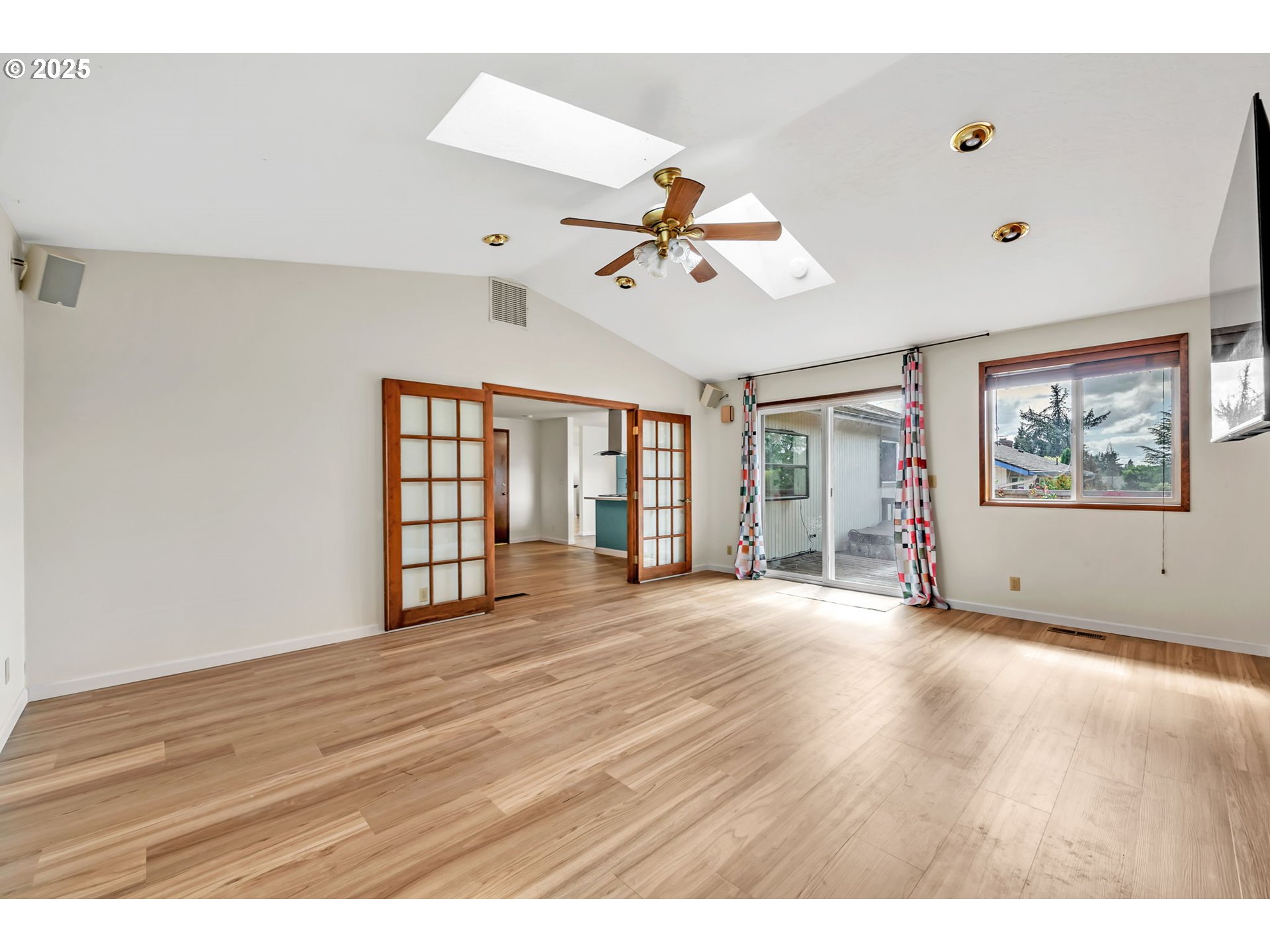 590 Granite Place Springfield, OR 97477 - Photo 8 of 21 a view of an empty room with a window and wooden floor
