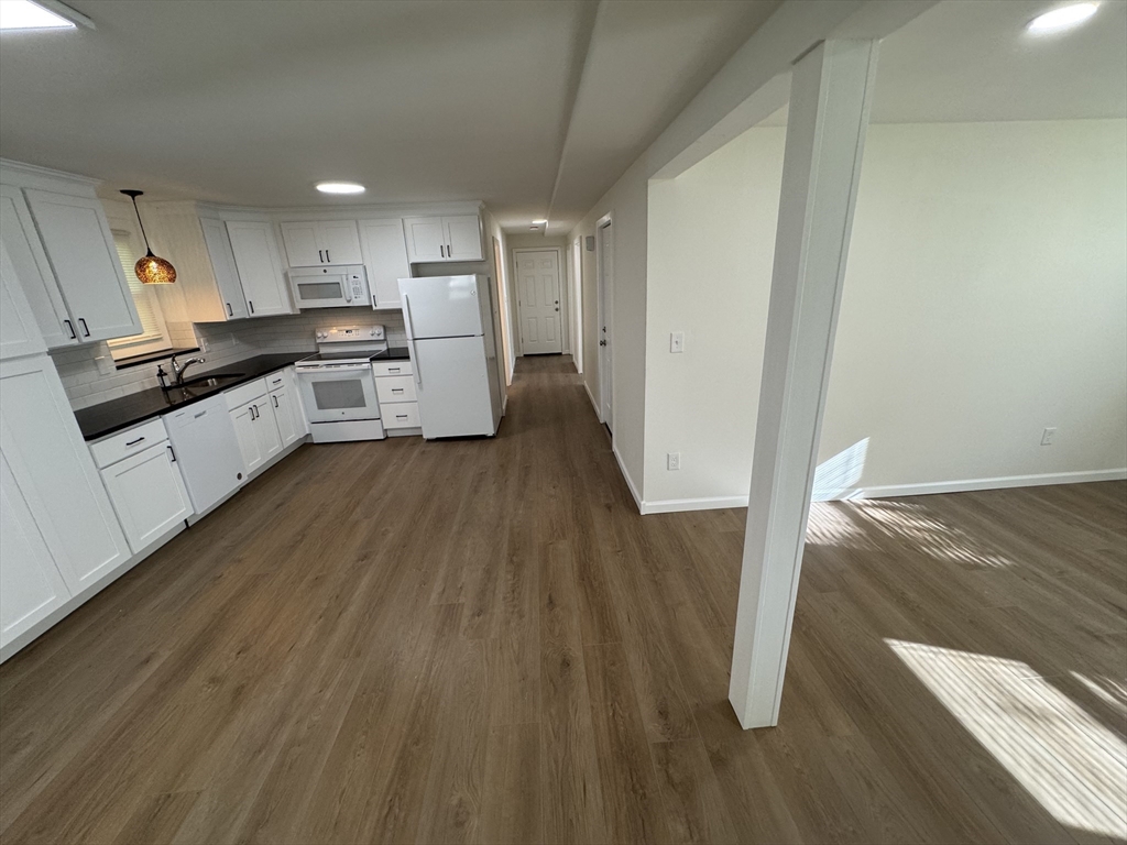 77 Cranston Street, Unit 1 Westfield, MA 01085 - Photo 6 of 11 a large kitchen with a wooden floor and electronic appliances