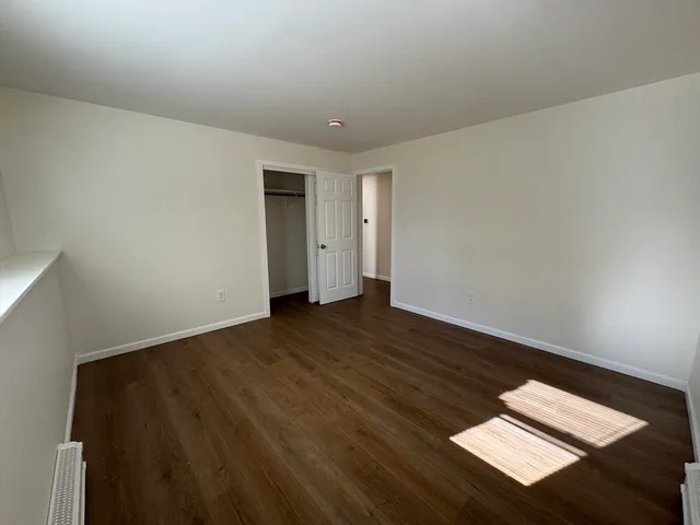 a view of an empty room and wooden floor