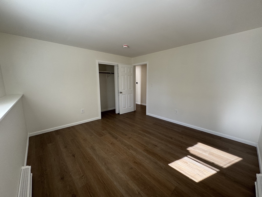 77 Cranston Street, Unit 1 Westfield, MA 01085 - Photo 8 of 11 a view of an empty room and wooden floor