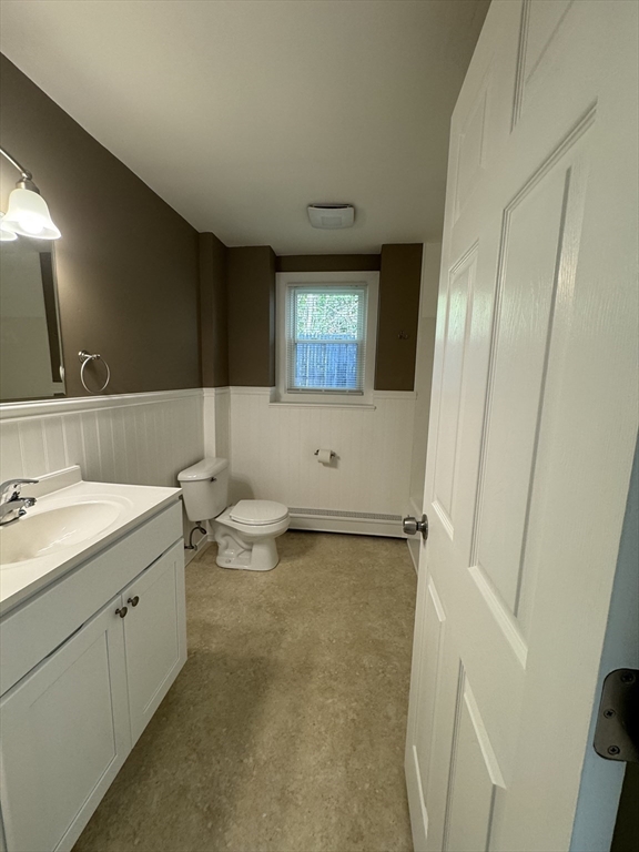 77 Cranston Street, Unit 1 Westfield, MA 01085 - Photo 9 of 11 a bathroom with a double vanity sink toilet and mirror