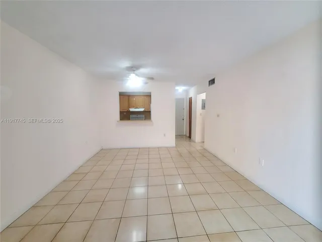 a view of an empty room and a window