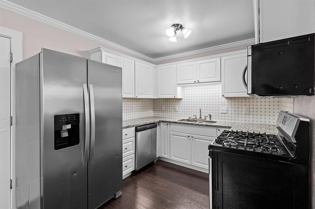 1135 Reed Circle Howe, TX 75459 - Photo 15 of 28 a kitchen with stainless steel appliances granite countertop a stove a refrigerator and a microwave