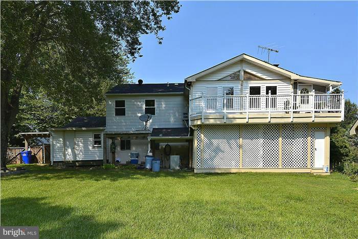 6716 Garrett Road Derwood, MD 20855 - Photo 29 of 30 a front view of a house with a garden and deck