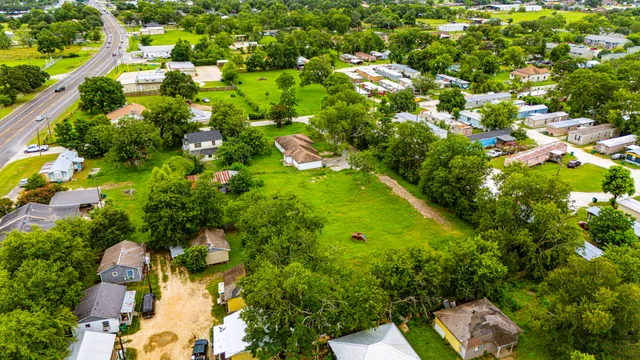 a view of a kitchen with a sink stove cabinets and empty room
