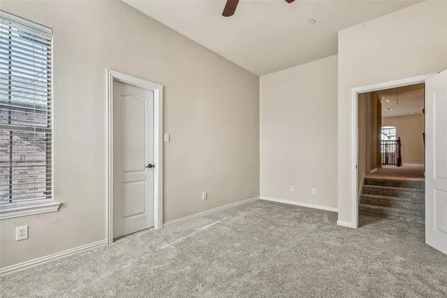 a view of a house with cars parked in front of it