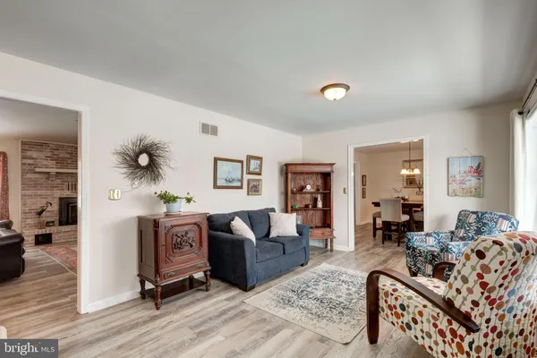 a living room with furniture a fireplace and a large window