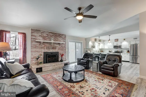 a living room with furniture fireplace and flat screen tv