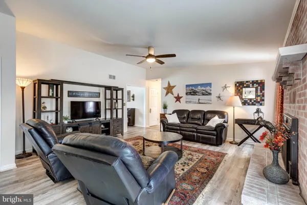 a large kitchen with a lot of counter space and wooden floor