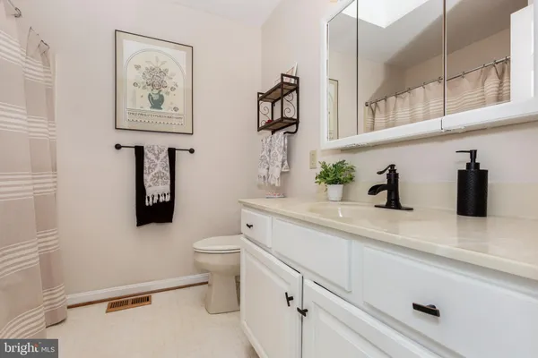 a room with wooden floor pool table and chairs