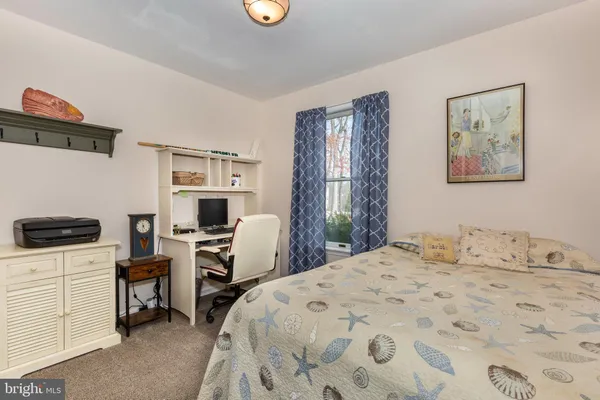 a room with furniture pool table and wooden floor