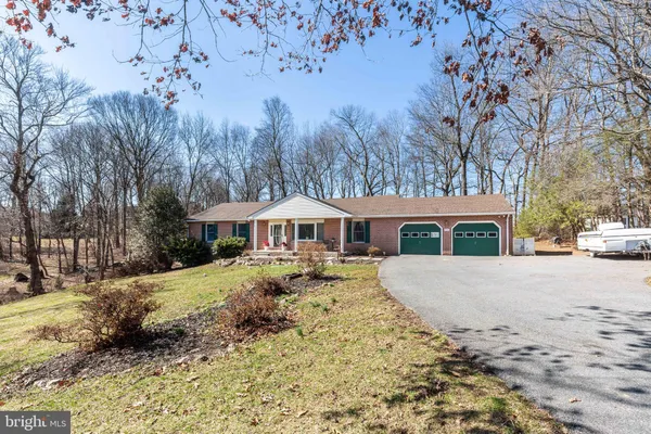 a view of a house with a yard covered in snow