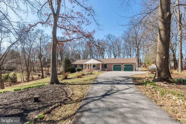 a view of a house with trees in the background