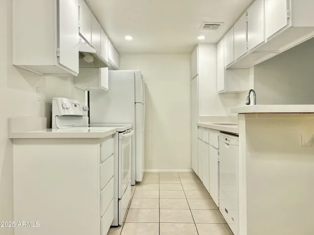 a kitchen with stainless steel appliances a refrigerator and a sink