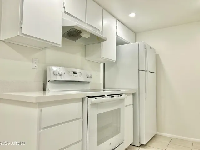 a kitchen with stainless steel appliances a refrigerator and cabinets