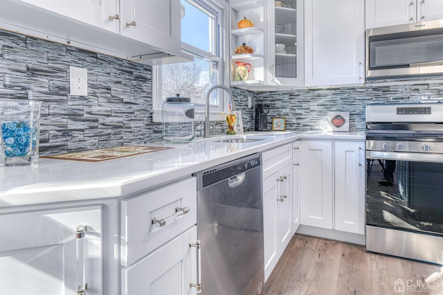 22 Devon Drive Piscataway, NJ 08854 - Photo 15 of 37 a kitchen with stainless steel appliances granite countertop a sink and a stove