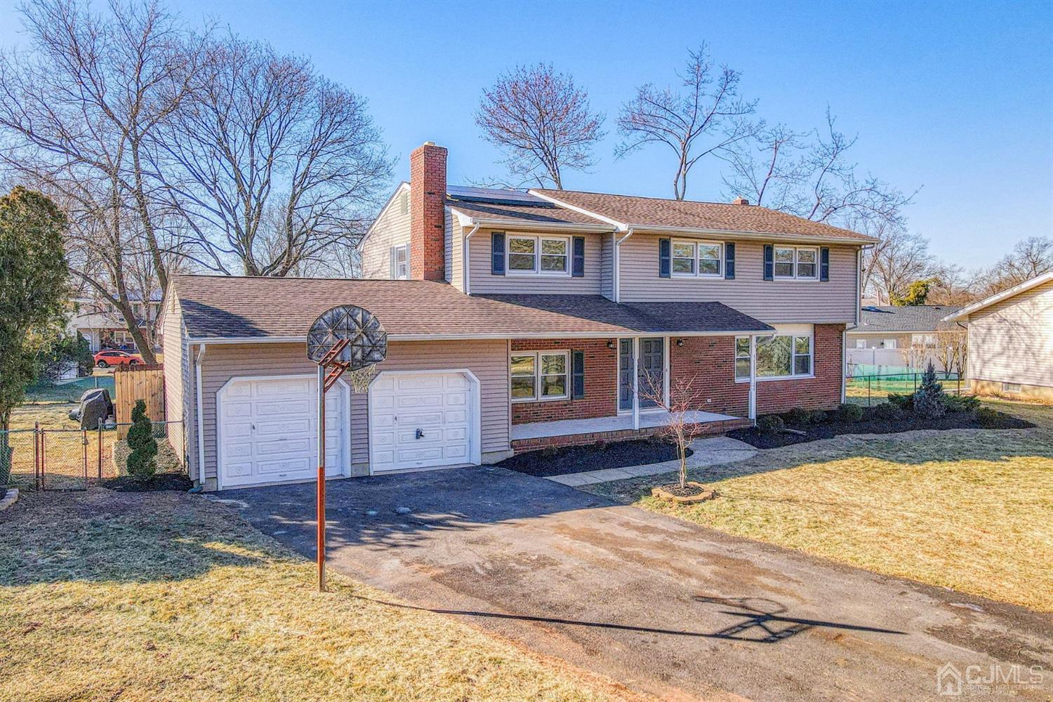 22 Devon Drive Piscataway, NJ 08854 - Photo 2 of 37 a front view of a house with a yard