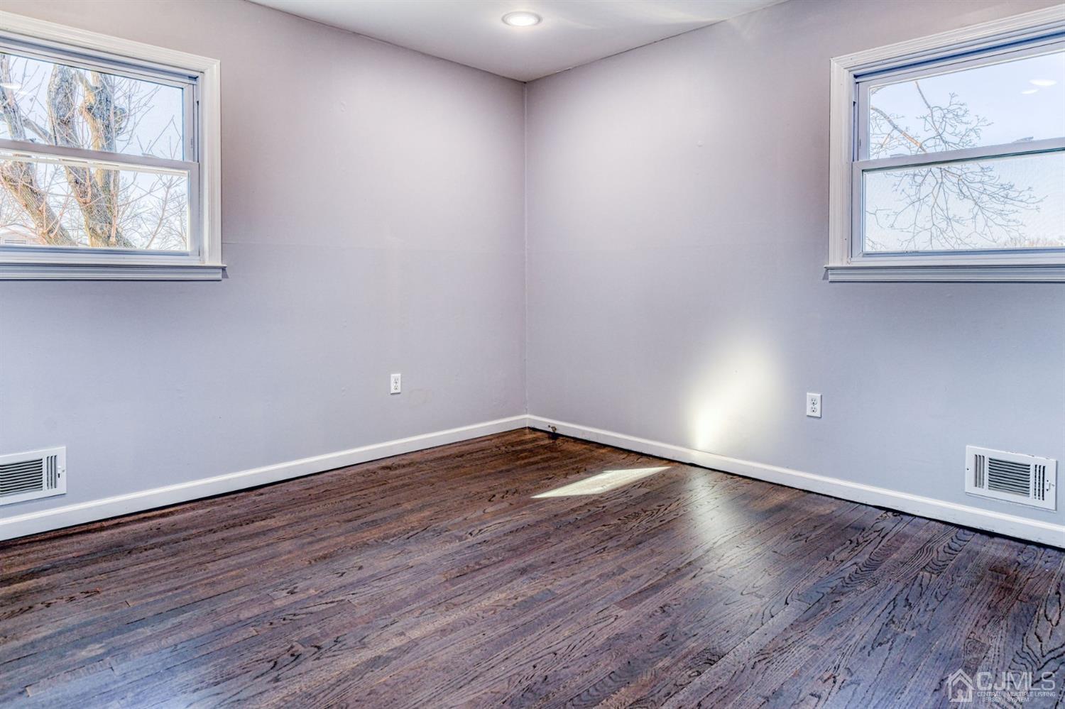 22 Devon Drive Piscataway, NJ 08854 - Photo 24 of 37 an empty room with wooden floor and windows