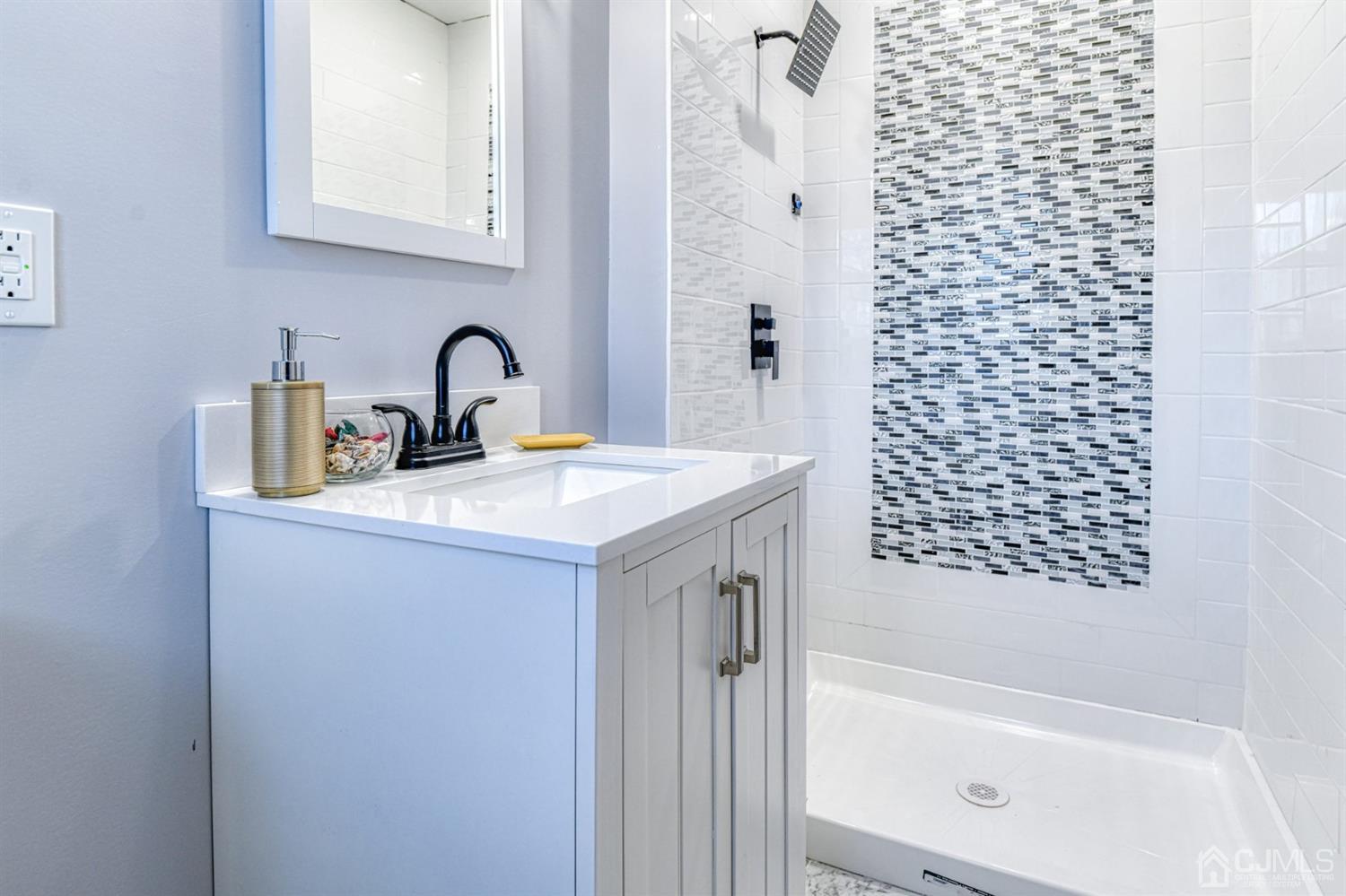 22 Devon Drive Piscataway, NJ 08854 - Photo 34 of 37 a bathroom with a sink a bathtub and a shower