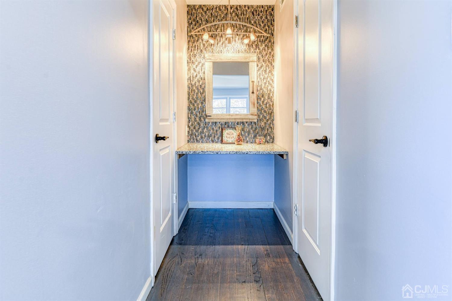 22 Devon Drive Piscataway, NJ 08854 - Photo 35 of 37 a view of a hallway with wooden floor and a large mirror