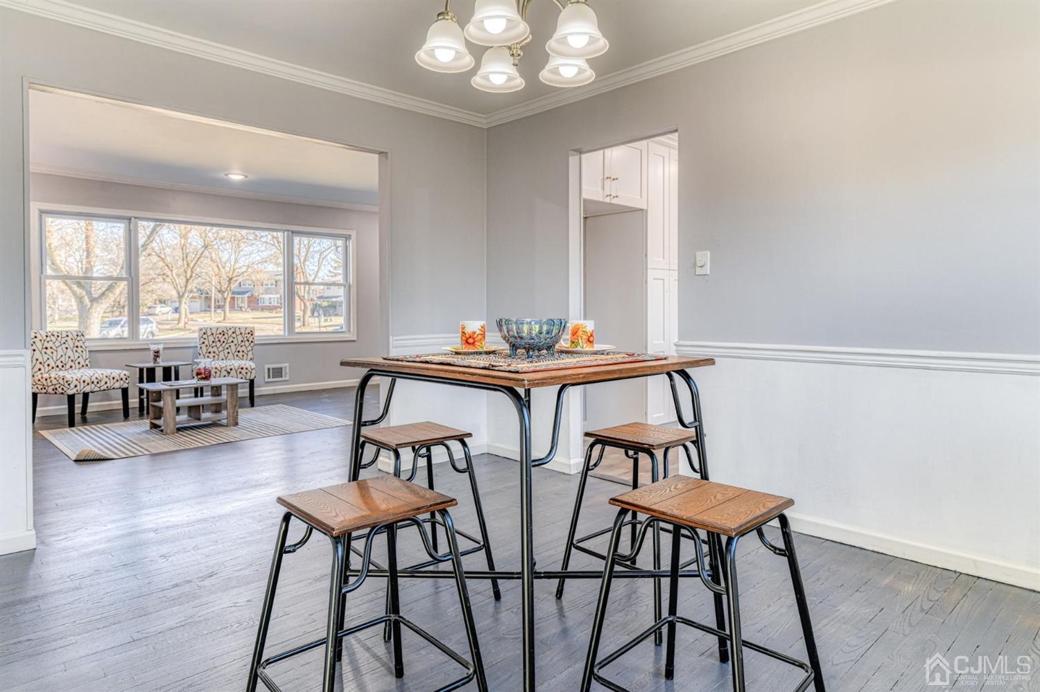 22 Devon Drive Piscataway, NJ 08854 - Photo 10 of 37 a view of a dining room with furniture wooden floor and a chandelier