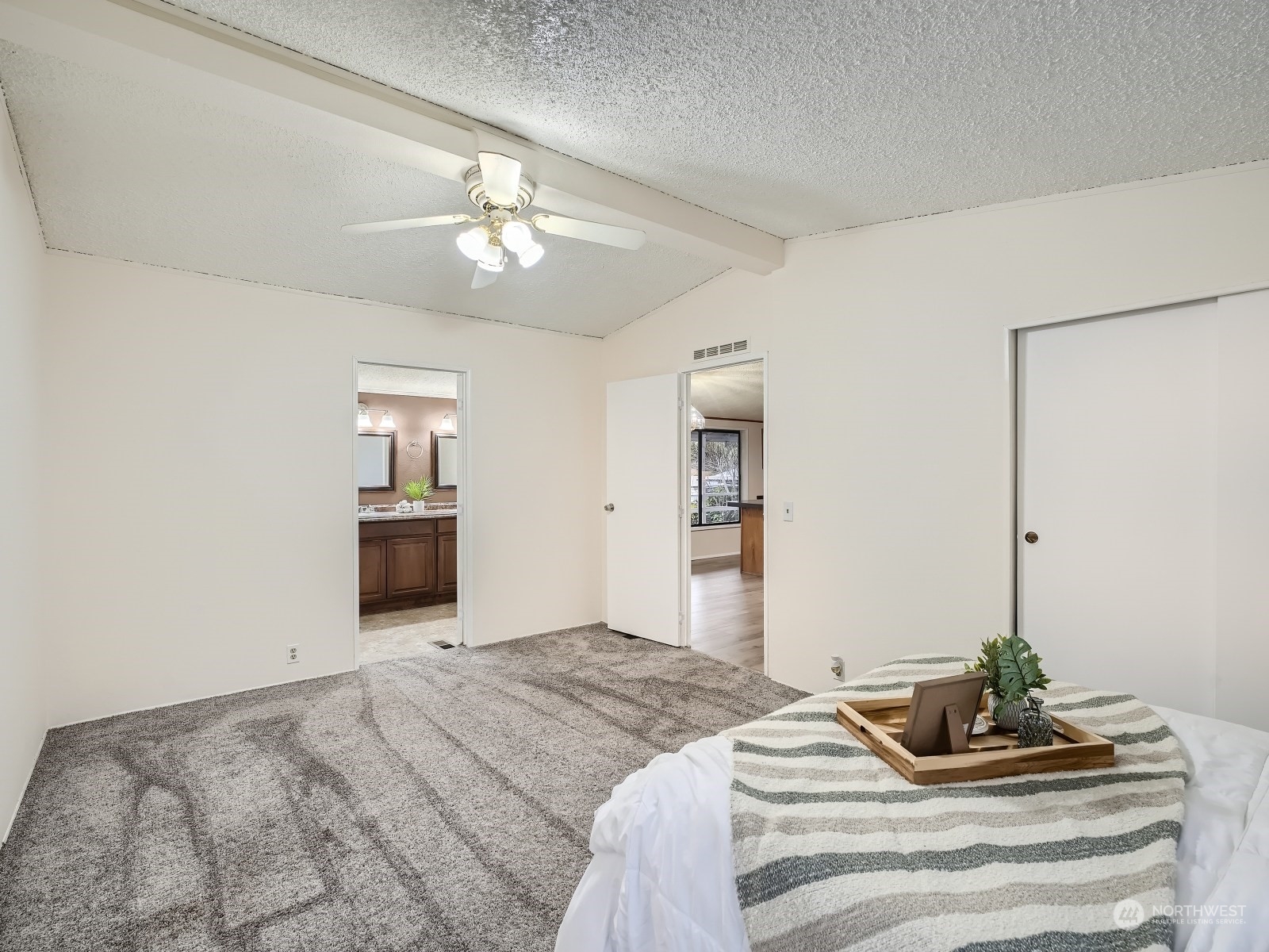 2505 South 371st Street, Unit 37 Federal Way, WA 98003 - Photo 11 of 27 a bedroom with a bed and a chandelier