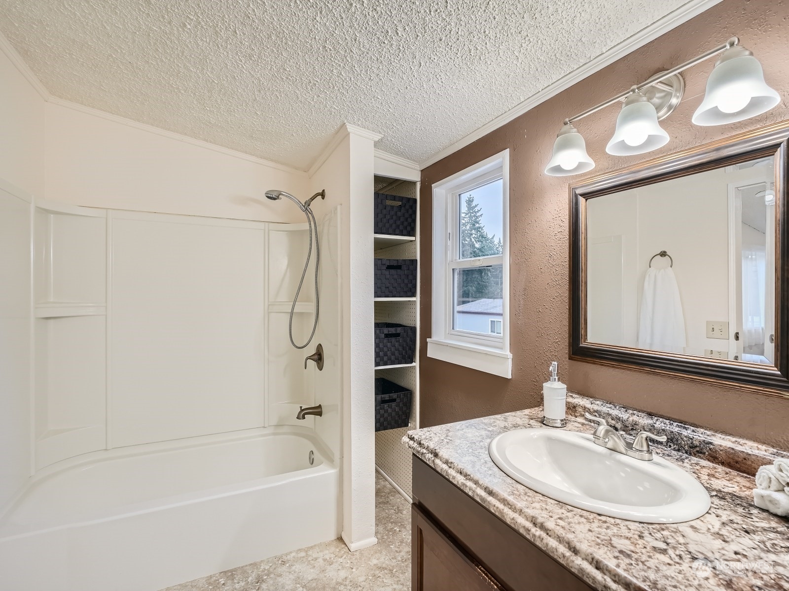 2505 South 371st Street, Unit 37 Federal Way, WA 98003 - Photo 12 of 27 a bathroom with a granite countertop sink a mirror a bathtub and shower