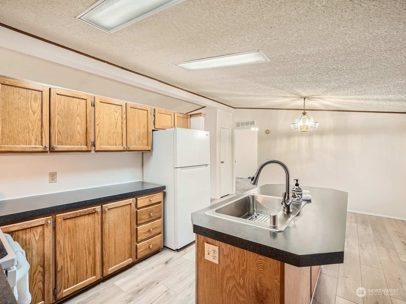 2505 South 371st Street, Unit 37 Federal Way, WA 98003 - Photo 8 of 27 a kitchen with a sink a table and chairs