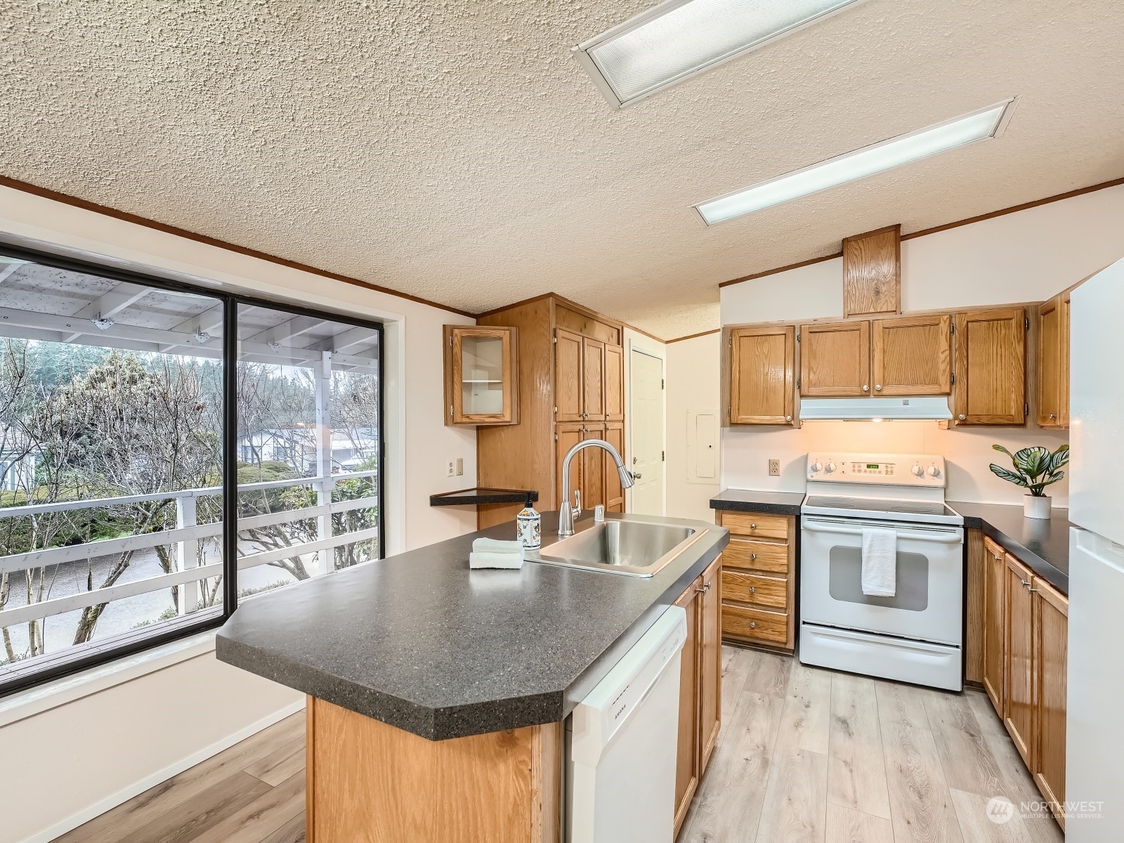 2505 South 371st Street, Unit 37 Federal Way, WA 98003 - Photo 9 of 27 a kitchen with stainless steel appliances granite countertop a sink a stove and a refrigerator
