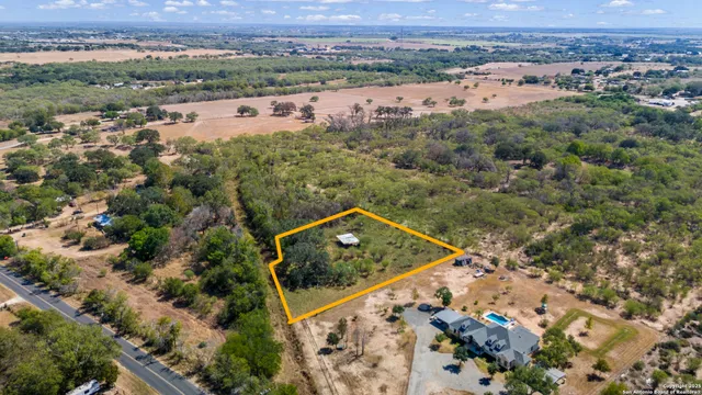 an aerial view of a house with a yard