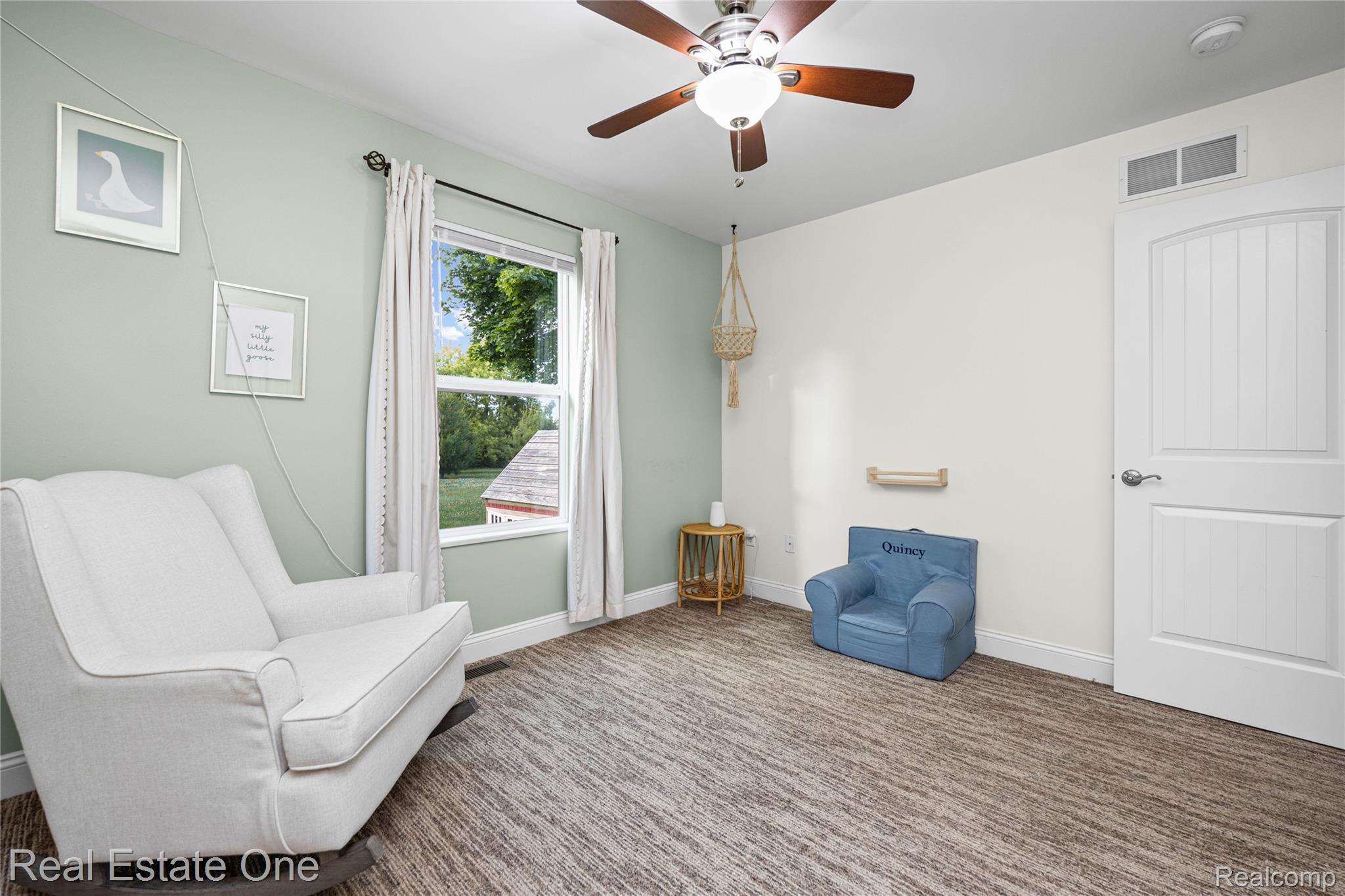 2479 Gibson Road Grand Blanc, MI 48439 - Photo 39 of 55 Bright room featuring a ceiling fan with light fixture, large window, and light-toned walls