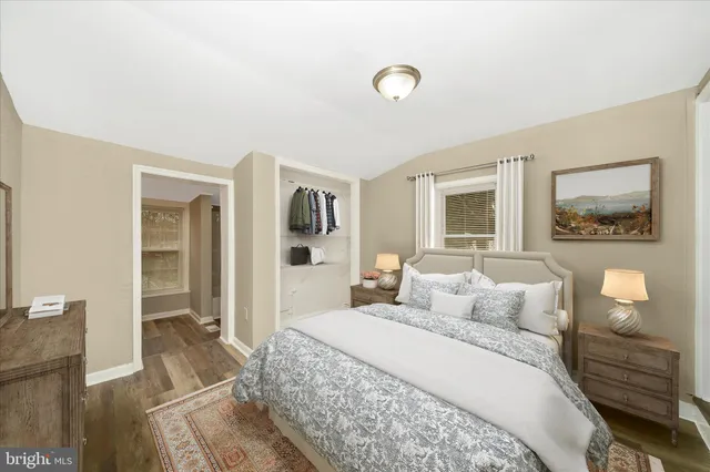 a bedroom with a bed and glass windows