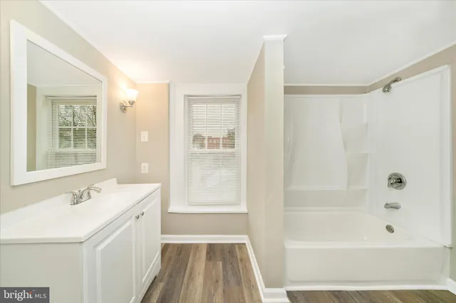 a bathroom with a sink a mirror and a bathtub