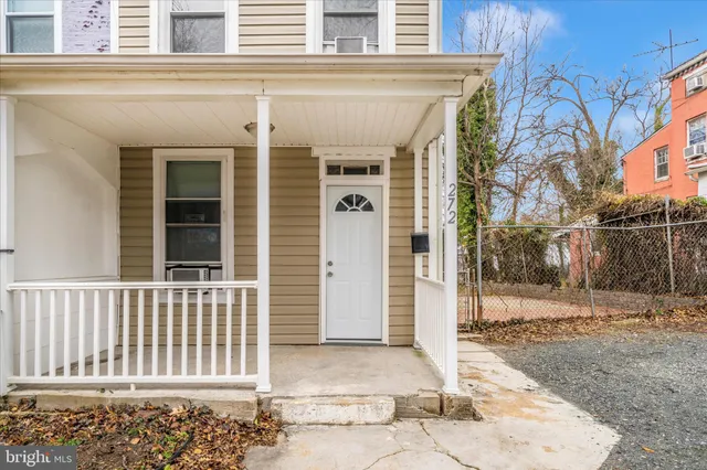 a front view of a house with a fence