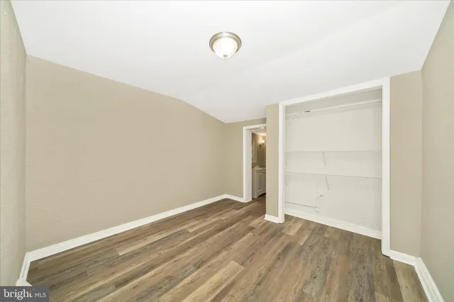 a view of a room with wooden floor