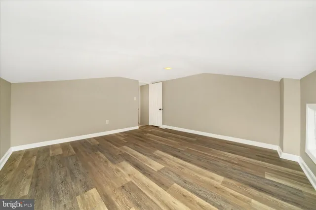 a view of an empty room and wooden floor