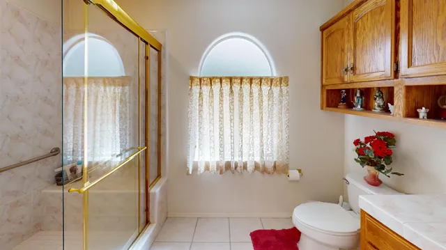 a bathroom with a toilet a sink and a window